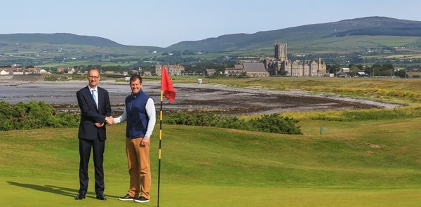 HM of King William’s College Joss Buchanan & Golf Pro Dave Adams on the Links with the English boarding school in the background | Dickinson School Consulting